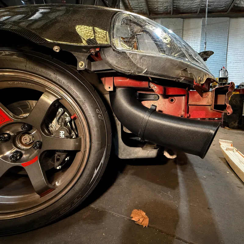 Cold intake system installed behind a Civic EK bumper